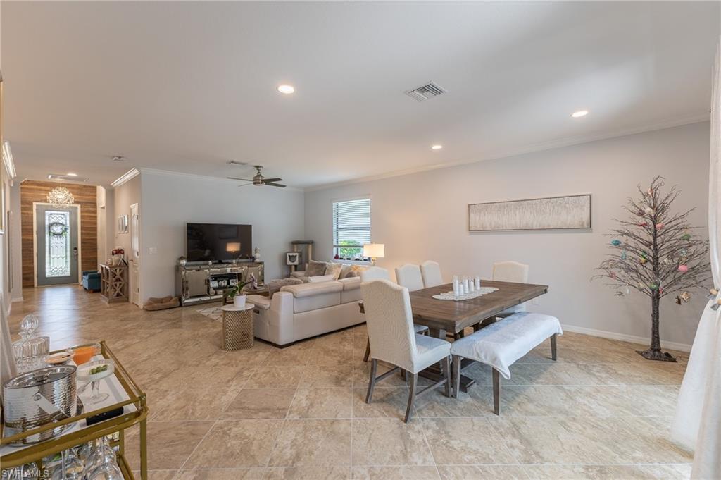 9231 Shadow Oak Lane Naples, FL 34120 - Photo 11 of 46 a living room with furniture a flat screen tv and a table