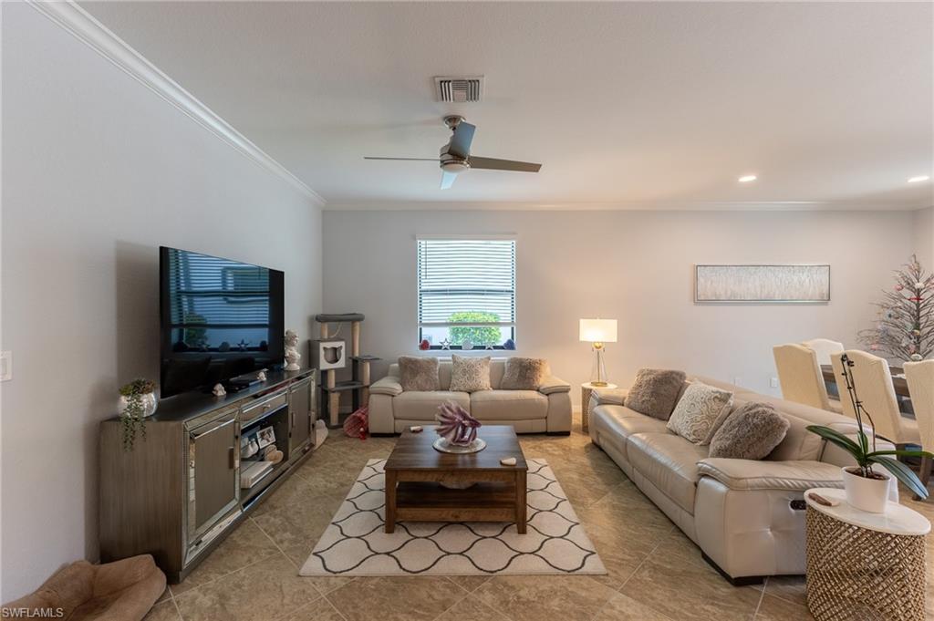 9231 Shadow Oak Lane Naples, FL 34120 - Photo 14 of 46 a living room with furniture and a flat screen tv
