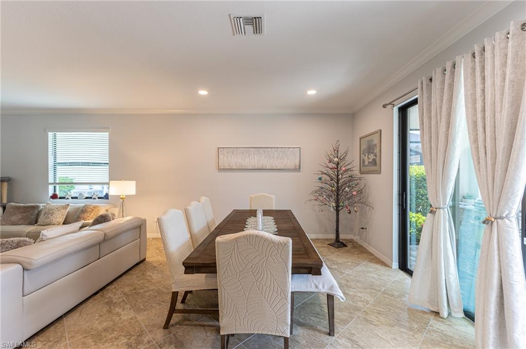 9231 Shadow Oak Lane Naples, FL 34120 - Photo 15 of 46 a living room with furniture and a large window