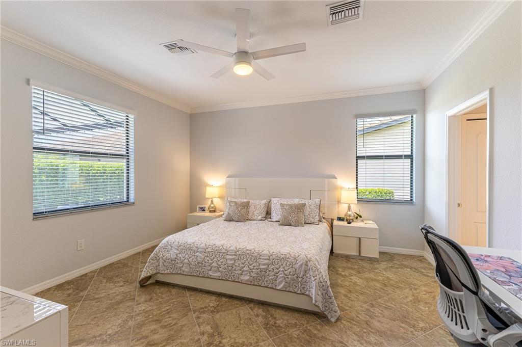 9231 Shadow Oak Lane Naples, FL 34120 - Photo 23 of 46 a bedroom with a bed and a large window