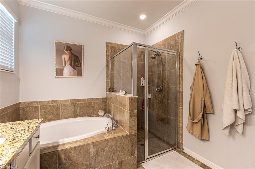 9231 Shadow Oak Lane Naples, FL 34120 - Photo 25 of 46 a bathroom with a tub and shower