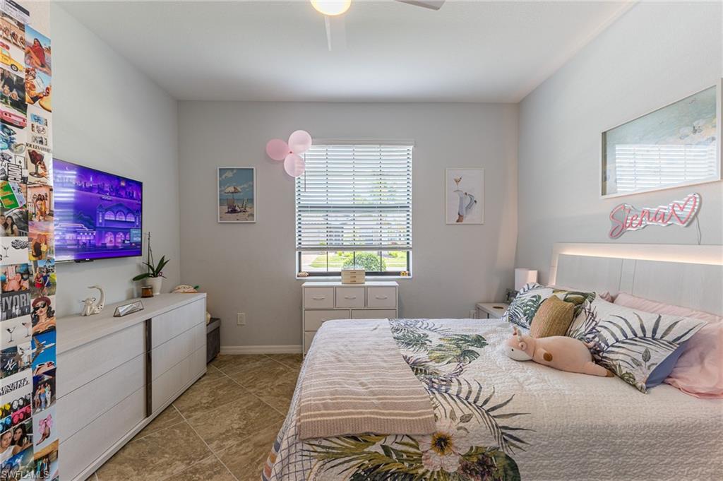 9231 Shadow Oak Lane Naples, FL 34120 - Photo 30 of 46 a bedroom with a bed and wooden floor