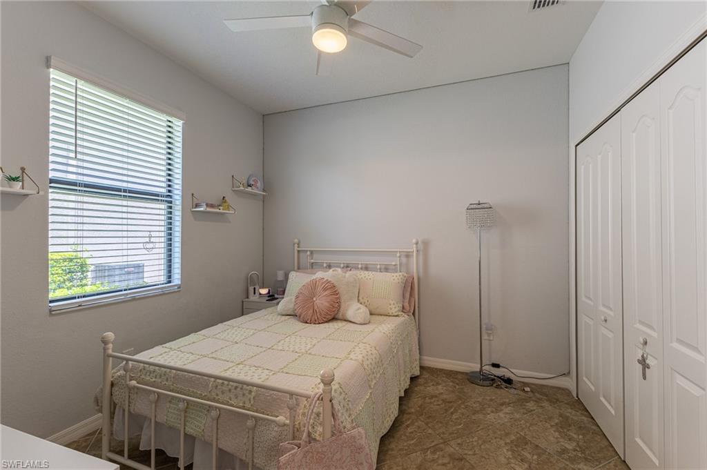 9231 Shadow Oak Lane Naples, FL 34120 - Photo 32 of 46 a bedroom with a bed and a window