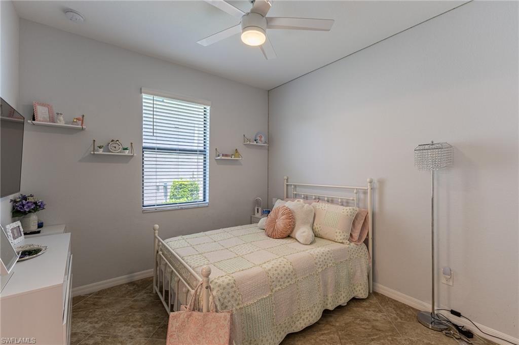 9231 Shadow Oak Lane Naples, FL 34120 - Photo 33 of 46 a bedroom with a bed and a window