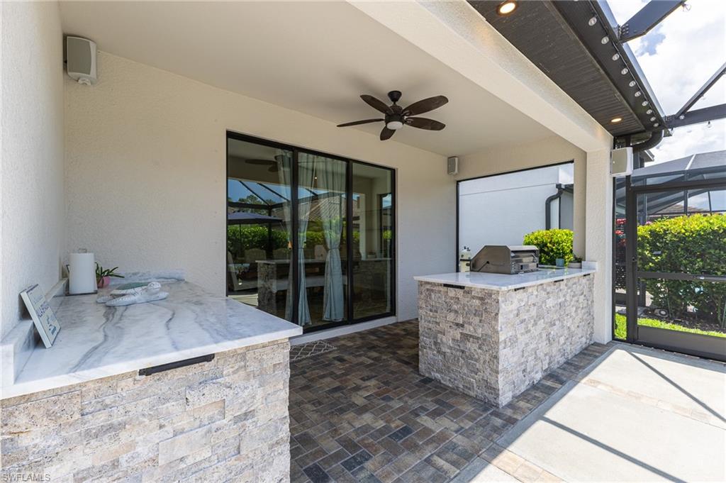 9231 Shadow Oak Lane Naples, FL 34120 - Photo 37 of 46 a living room with a couch and a chandelier