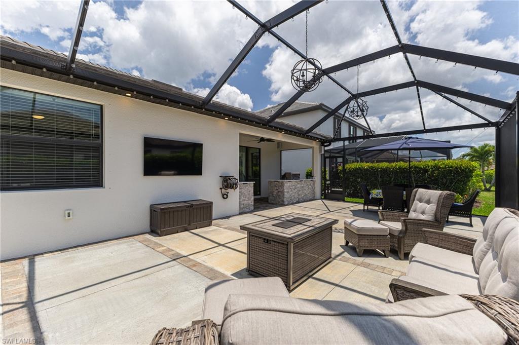 9231 Shadow Oak Lane Naples, FL 34120 - Photo 6 of 46 a outdoor space with patio the couches and a flat tv screen