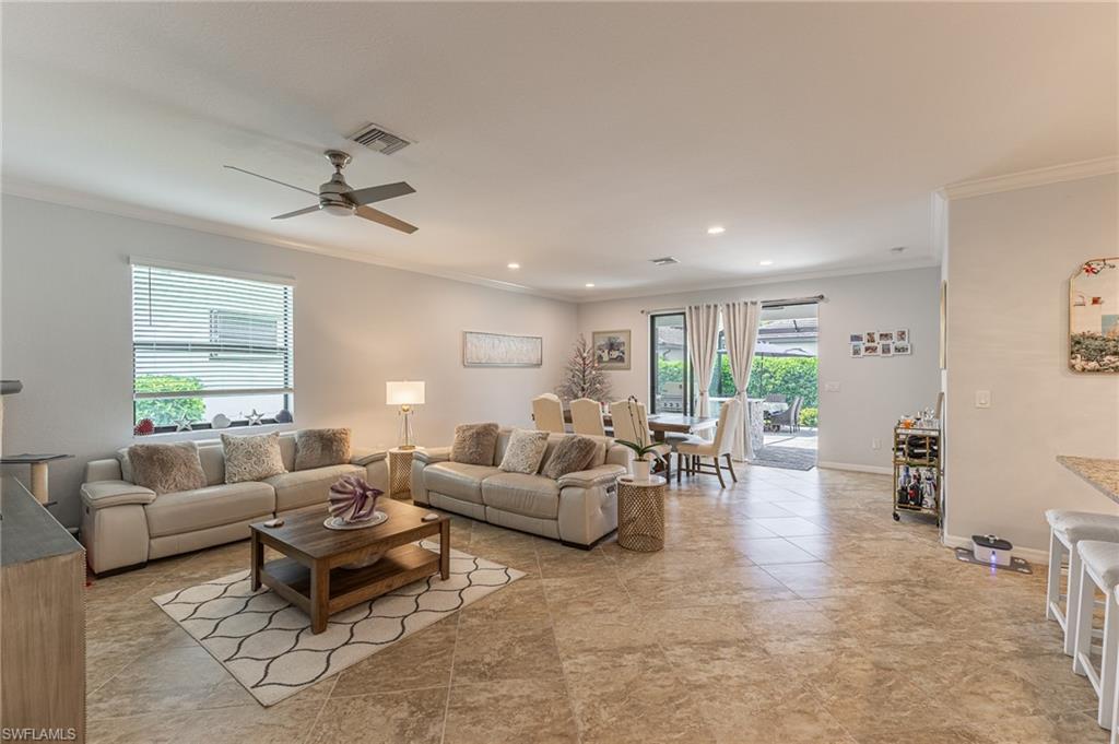 9231 Shadow Oak Lane Naples, FL 34120 - Photo 10 of 46 a living room with furniture and a large window