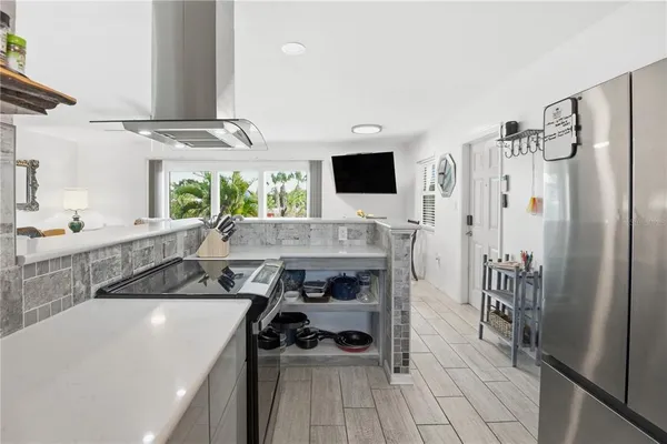 a kitchen with stainless steel appliances a sink stove and cabinets