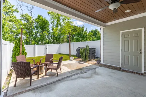 a view of a patio with table and chairs and potted plants