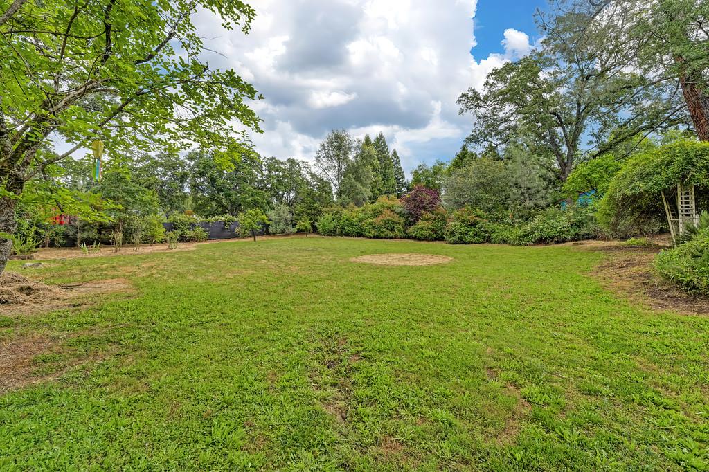 6689 Rhodes Avenue Placerville, CA 95667 - Photo 47 of 60 a view of a green field with wooden fence