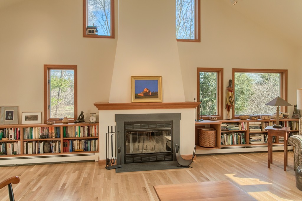 814 Langen Road Lancaster, MA 01523 - Photo 9 of 30 a living room with furniture a rug and a fireplace