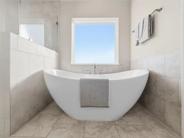 a spacious bathroom with shower bathtub and sink