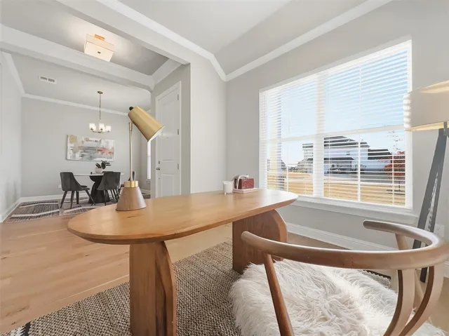 a dining room with furniture a rug and a window