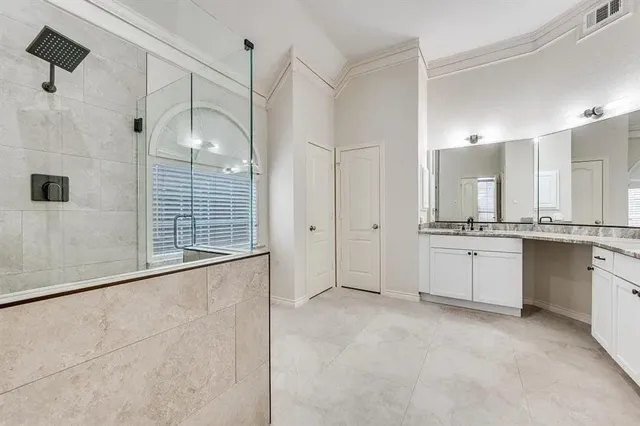 a bathroom with a granite countertop sink mirror and a shower