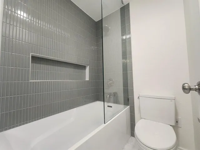 a bathroom with a toilet and bathtub
