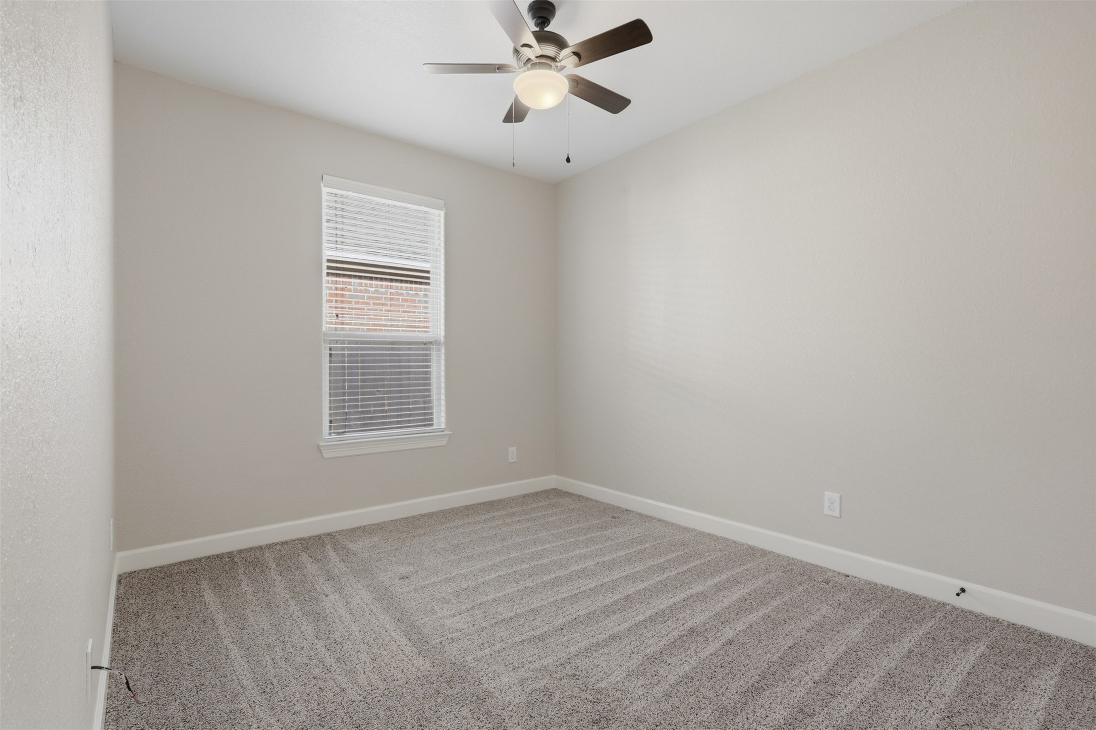 721 Rufina Street League City, TX 77573 - Photo 19 of 33 Another spacious secondary bedroom features fresh carpeting, neutral designer paint, and abundant natural light. Its versatile proportions make furnishing effortless while providing comfort and privacy for family or overnight guests.