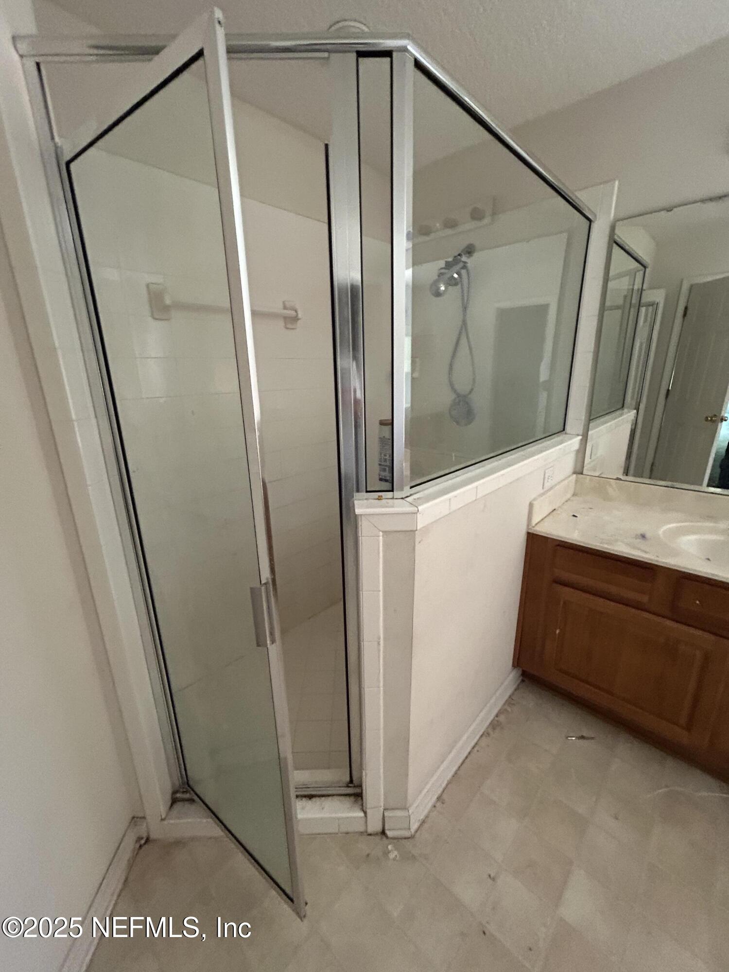 6369 Spring Hollow Court Jacksonville, FL 32218 - Photo 11 of 20 a bathroom with a tub and a glass door shower