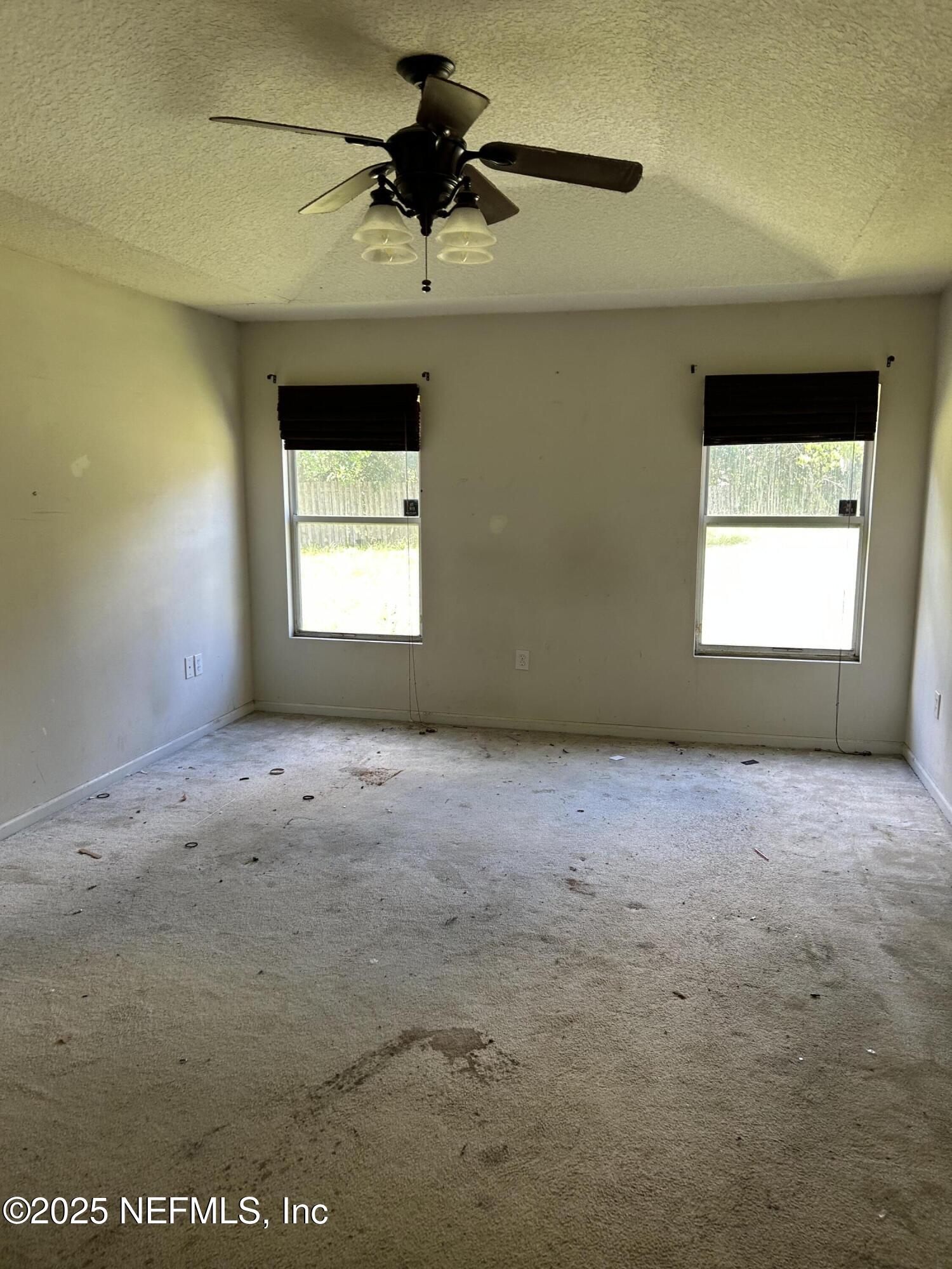 6369 Spring Hollow Court Jacksonville, FL 32218 - Photo 14 of 20 an empty room with a window and a fan