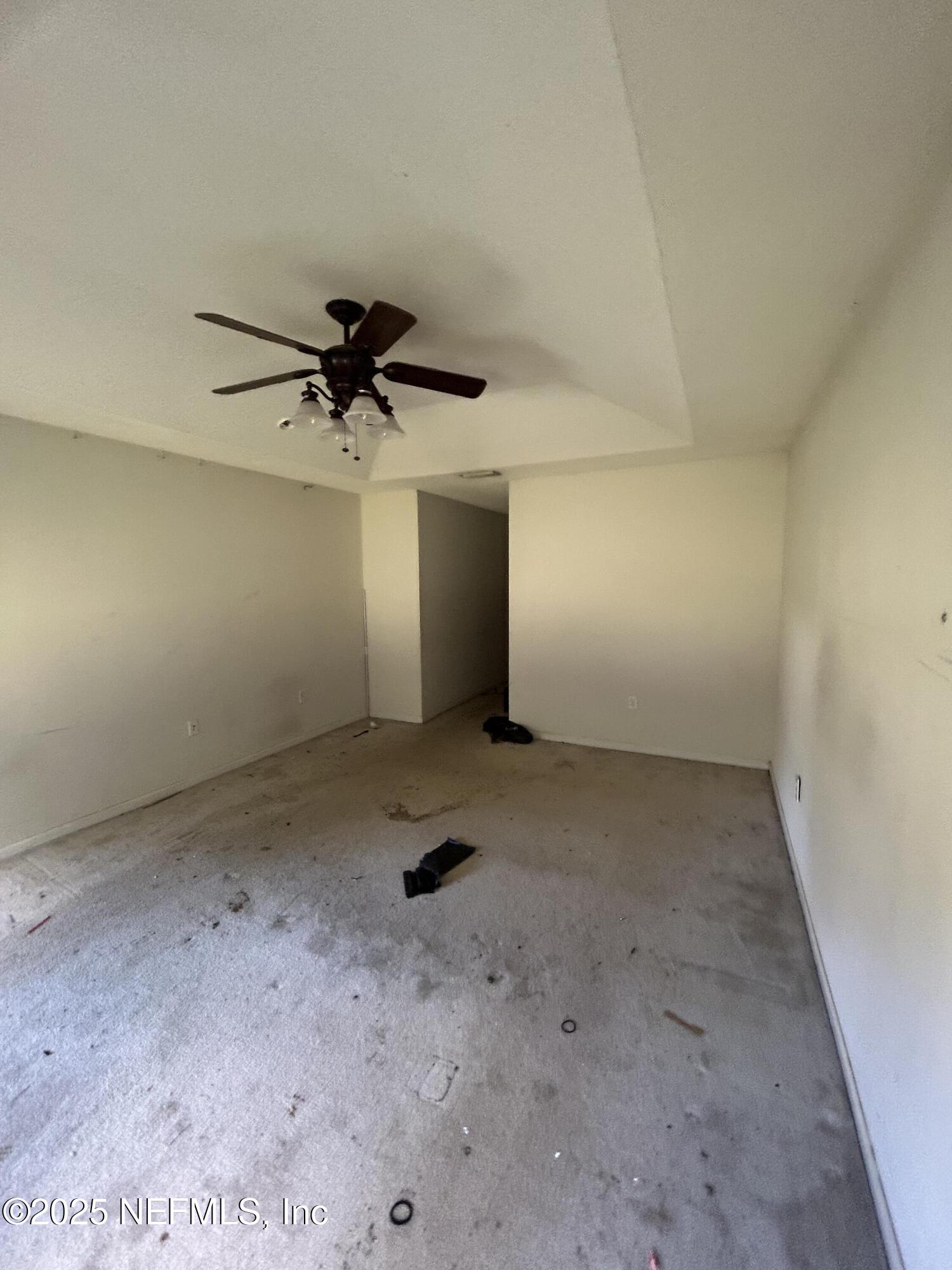 6369 Spring Hollow Court Jacksonville, FL 32218 - Photo 15 of 20 an empty room with a ceiling fan and carpet