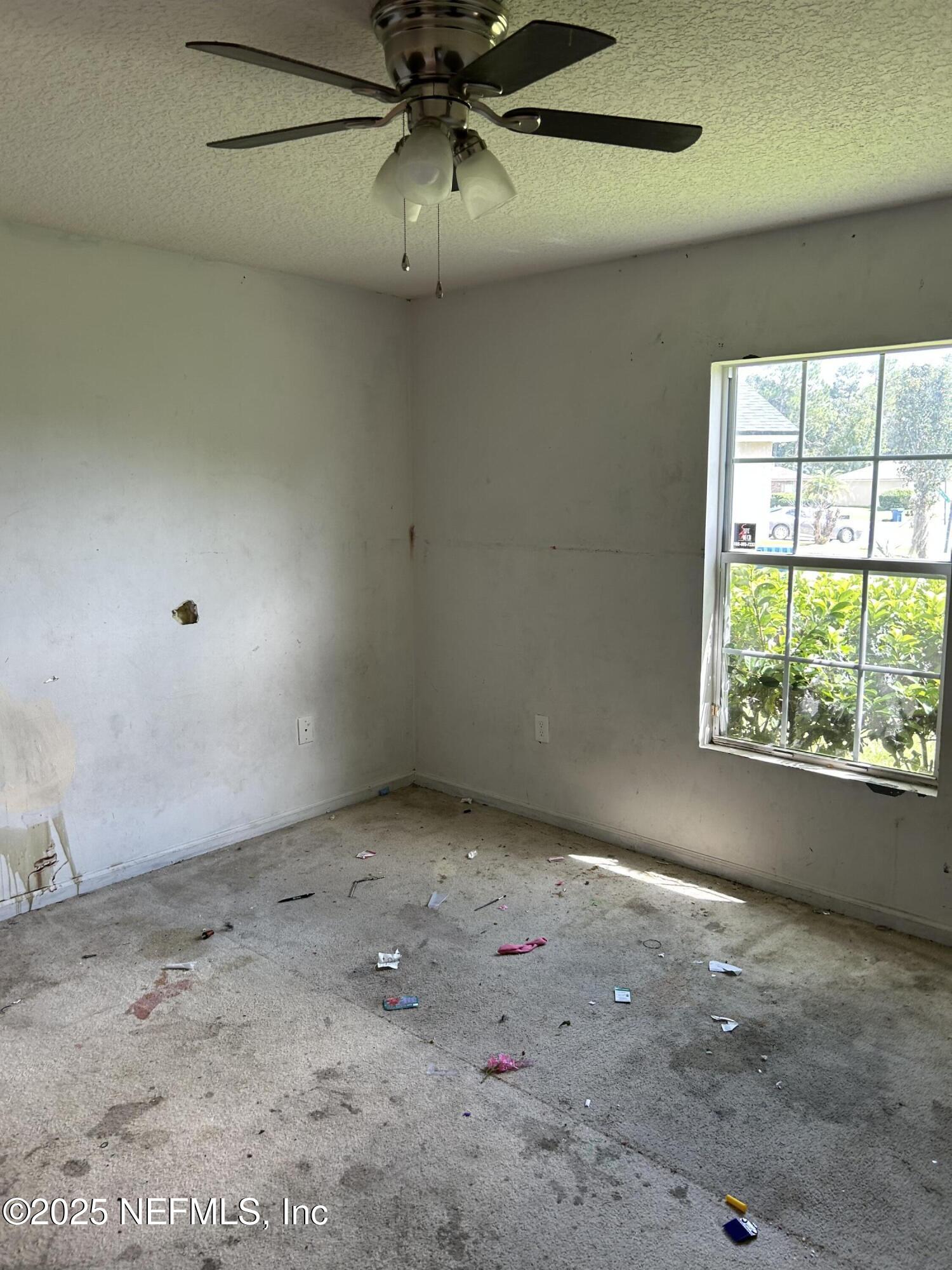 6369 Spring Hollow Court Jacksonville, FL 32218 - Photo 17 of 20 wooden floor in an empty room with a window