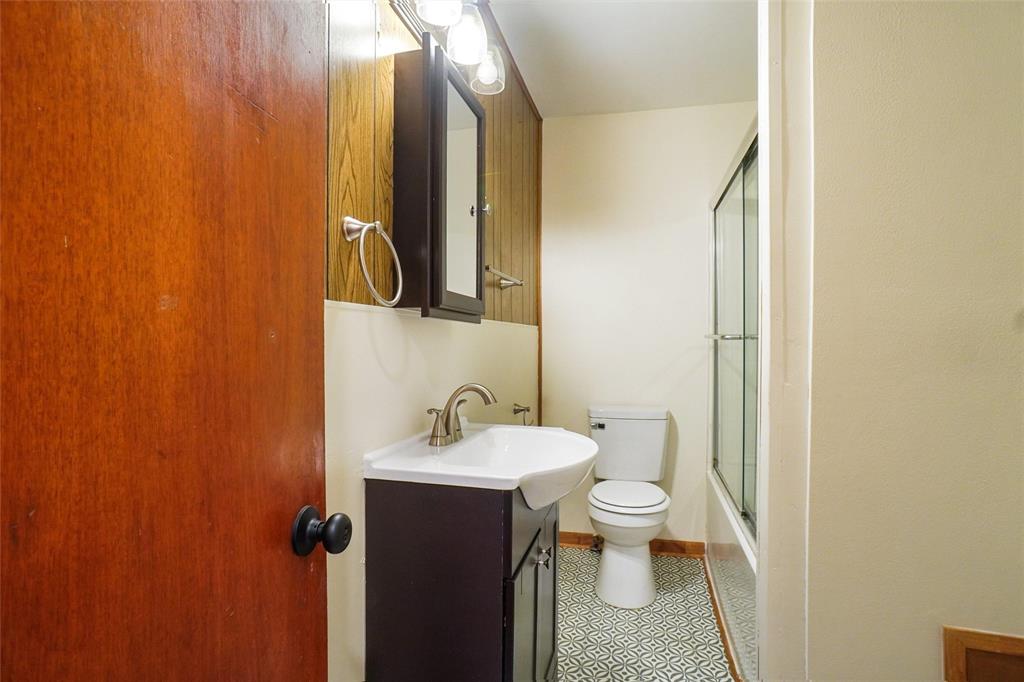 321 West Highway 199 Springtown, TX 76082 - Photo 12 of 22 a bathroom with a sink and mirror with toilet