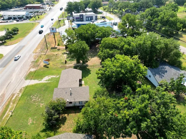 an aerial view of a house with a yard and lake view