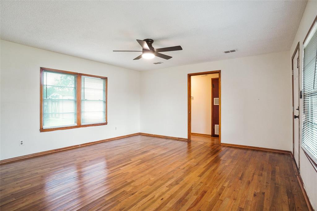 321 West Highway 199 Springtown, TX 76082 - Photo 5 of 22 a view of an empty room with wooden floor and a window