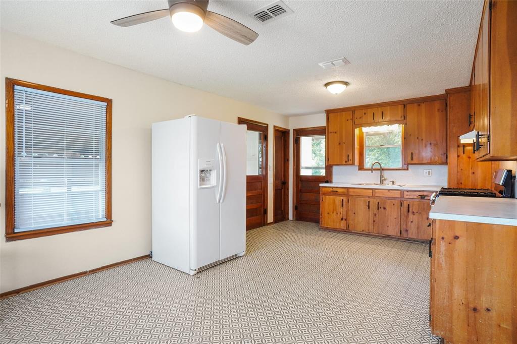 321 West Highway 199 Springtown, TX 76082 - Photo 8 of 22 a large white kitchen with a window and a refrigerator