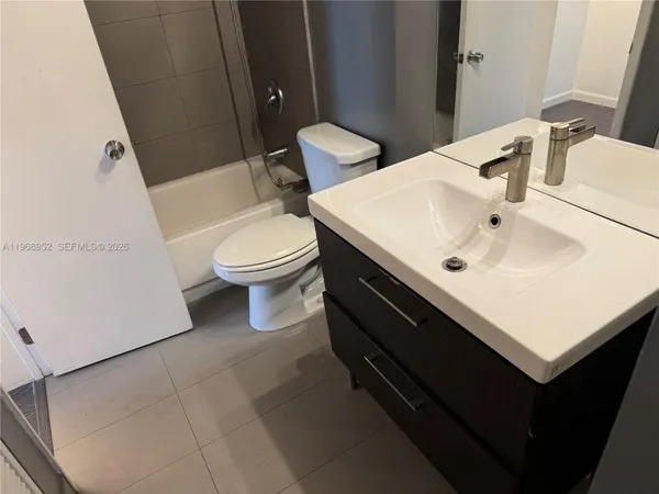 a bathroom with a sink toilet and mirror