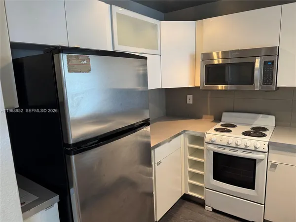 a kitchen with a stove microwave and refrigerator