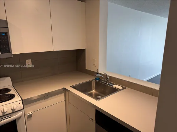 a kitchen with a sink and cabinets