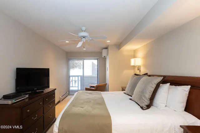 a bedroom with a bed and a flat screen tv