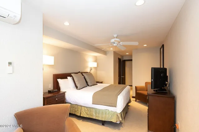 a bedroom with a bed and flat screen tv