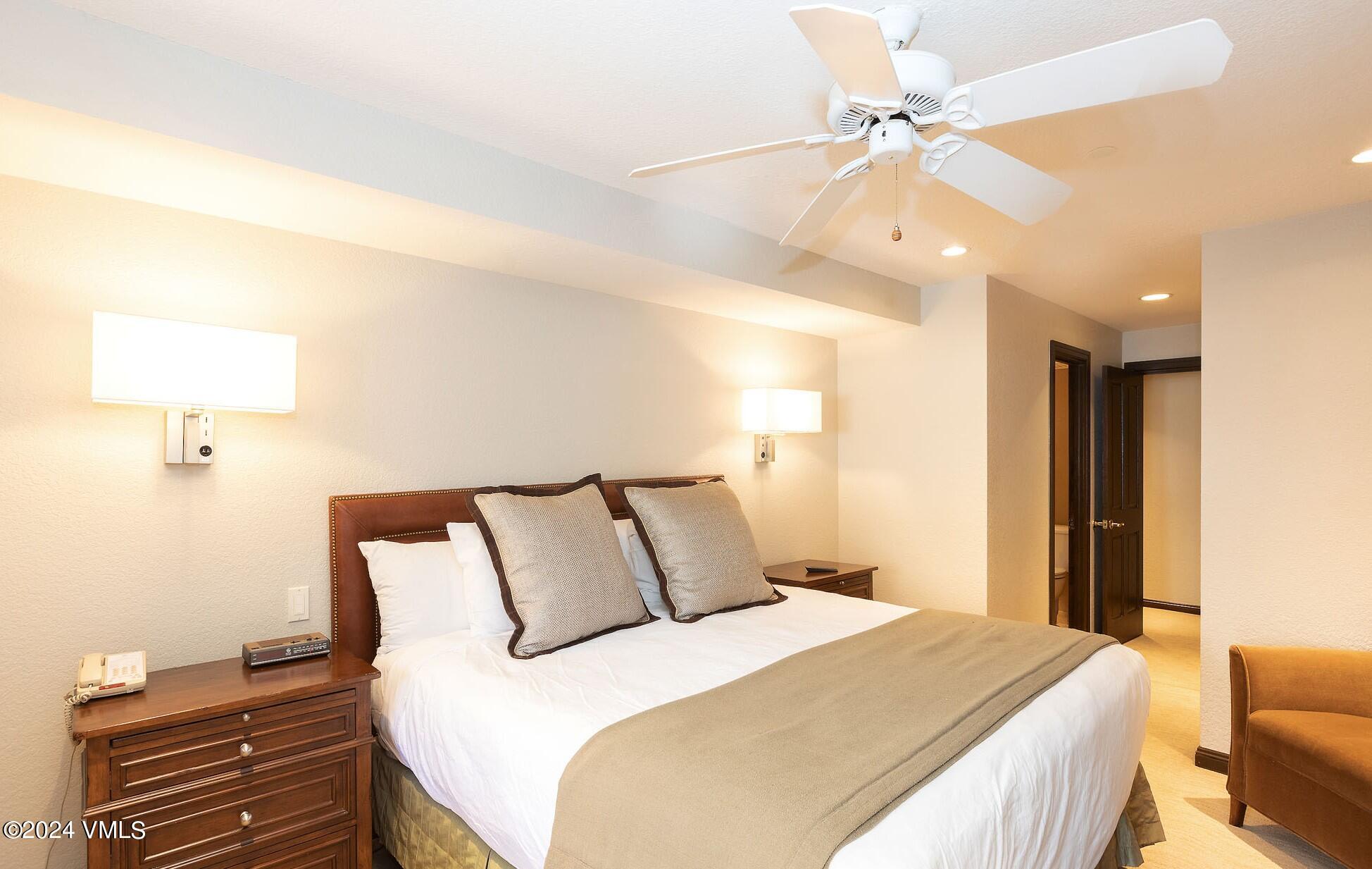 210 Offerson Road, Unit R215 WEEK 47 Beaver Creek, CO 81620 - Photo 14 of 26 a bedroom with a bed and a chandelier