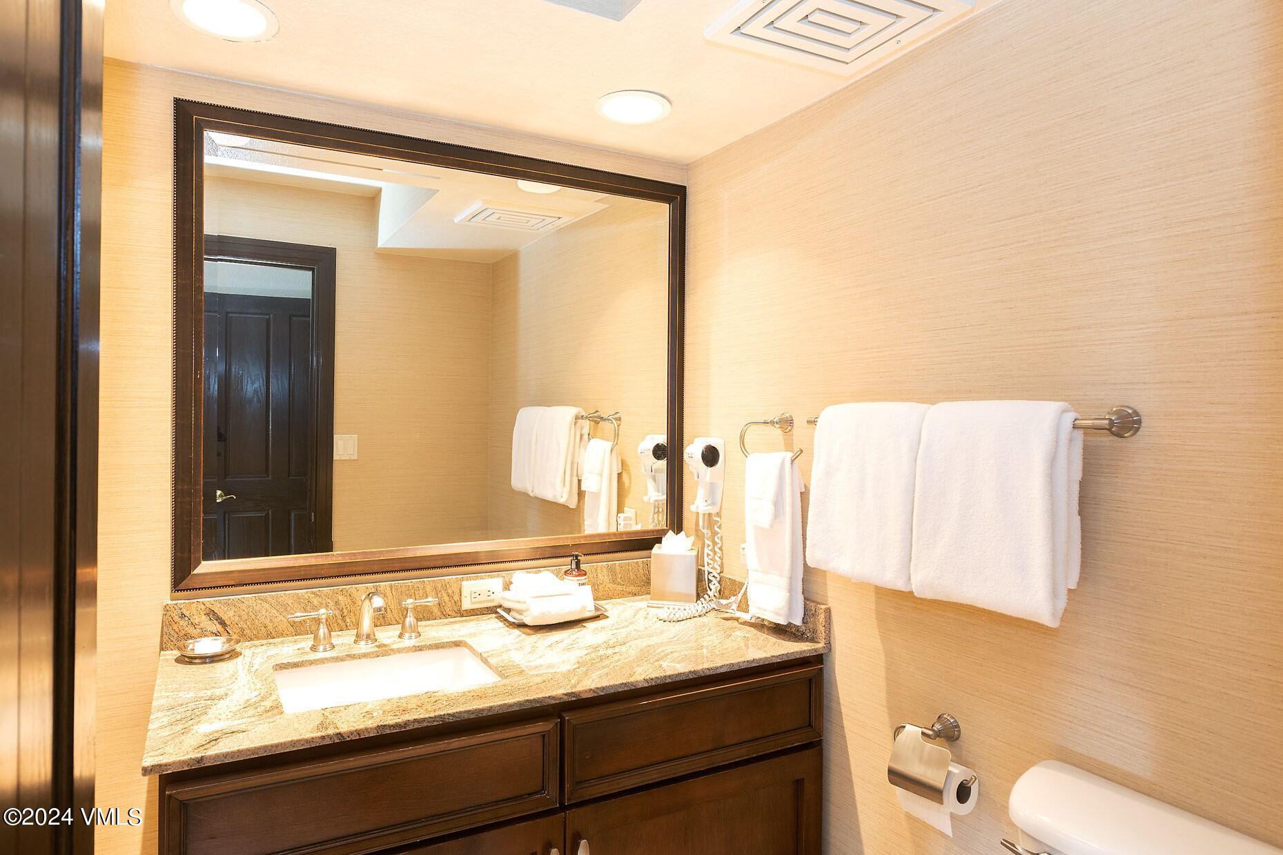 210 Offerson Road, Unit R215 WEEK 47 Beaver Creek, CO 81620 - Photo 20 of 26 a bathroom with a granite countertop sink and a mirror