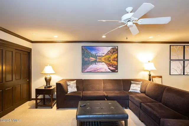 a living room with furniture and a lamp