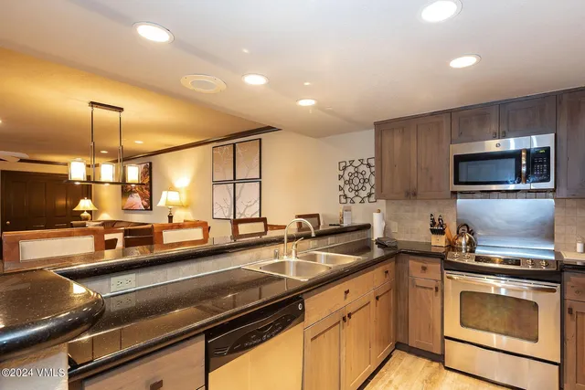 a kitchen with a sink appliances and cabinets
