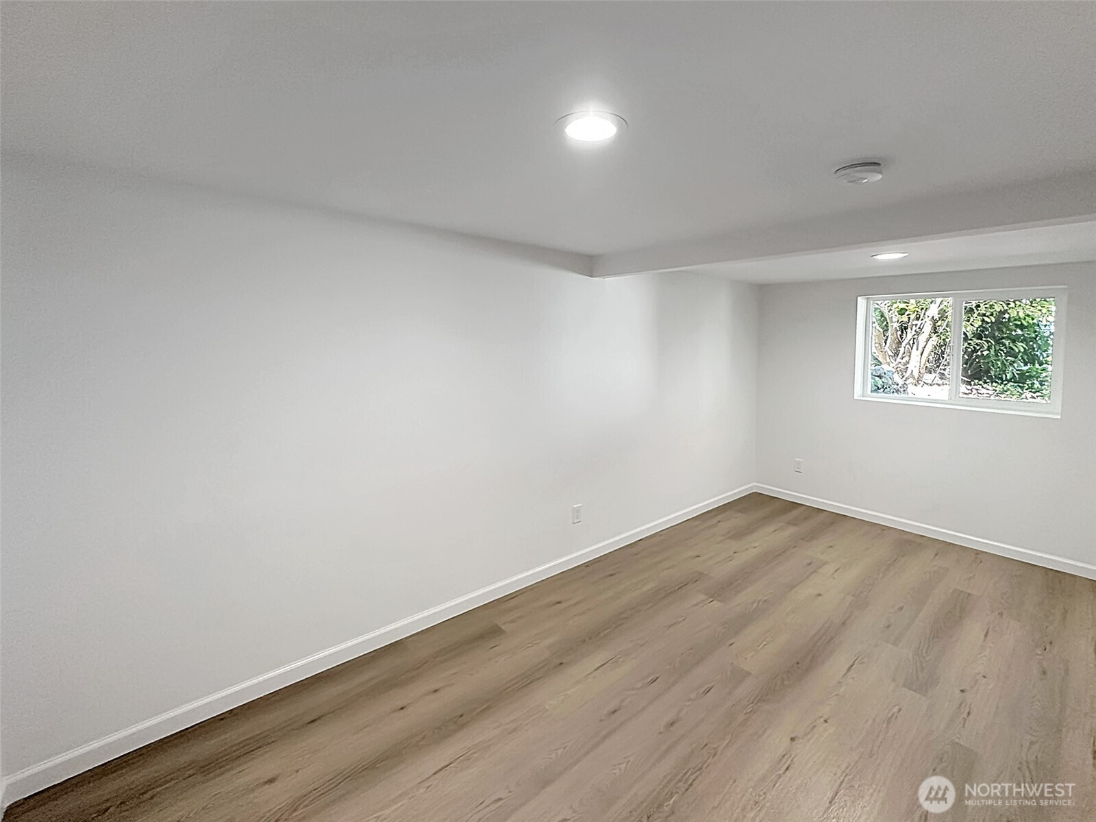 7403 Beverly Boulevard Everett, WA 98203 - Photo 15 of 19 an empty room with wooden floor and windows
