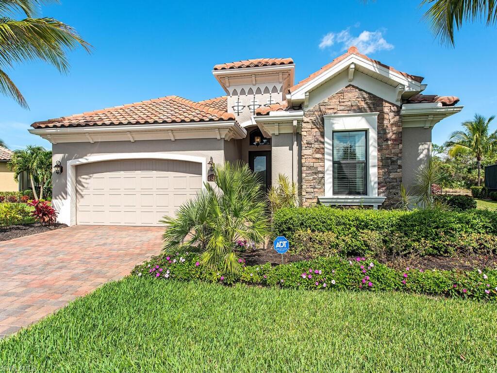 9413 Rialto Drive Naples, FL 34113 - Photo 1 of 12 a front view of a house with a yard