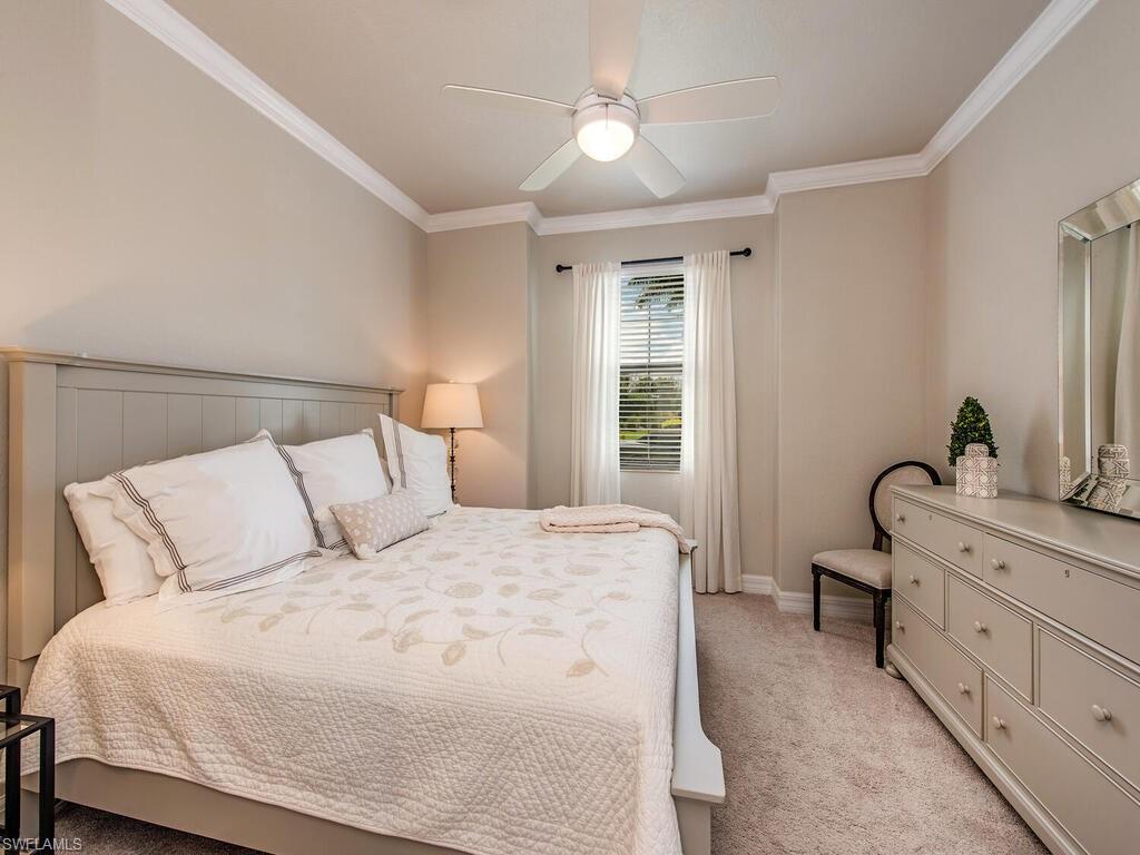 9413 Rialto Drive Naples, FL 34113 - Photo 8 of 12 a bedroom with a bed and a dresser