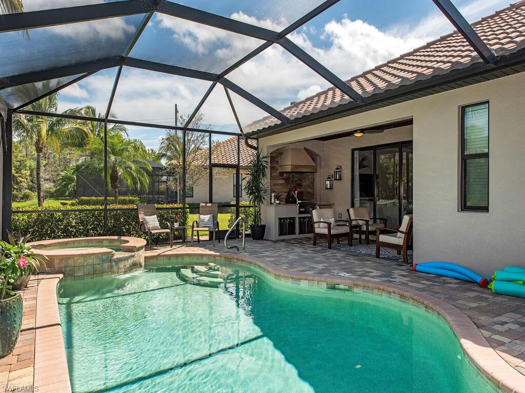 9413 Rialto Drive Naples, FL 34113 - Photo 10 of 12 a swimming pool with outdoor seating and yard