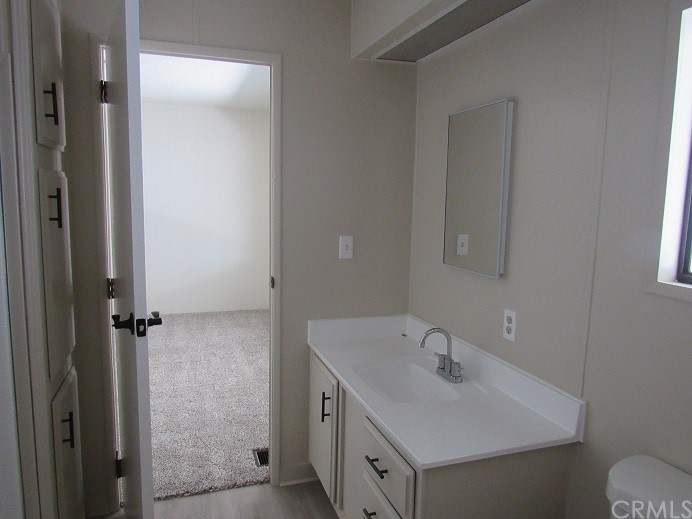 601 North Kirby Street, Unit 557 Hemet, CA 92545 - Photo 11 of 13 a bathroom with a sink and a toilet
