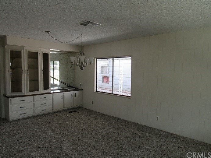 601 North Kirby Street, Unit 557 Hemet, CA 92545 - Photo 4 of 13 an empty room with windows