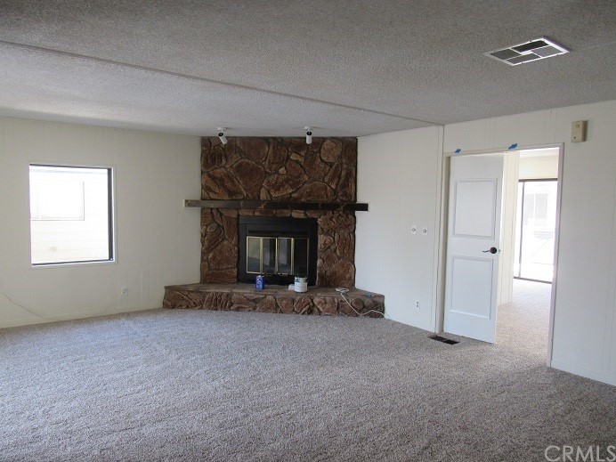 601 North Kirby Street, Unit 557 Hemet, CA 92545 - Photo 6 of 13 a view of an empty room with a fireplace