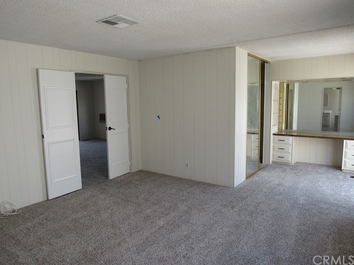 601 North Kirby Street, Unit 557 Hemet, CA 92545 - Photo 7 of 13 an empty room with closet and windows