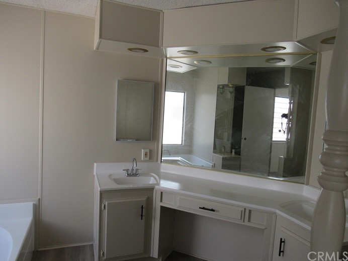 601 North Kirby Street, Unit 557 Hemet, CA 92545 - Photo 9 of 13 a bathroom with a double vanity sink and a mirror