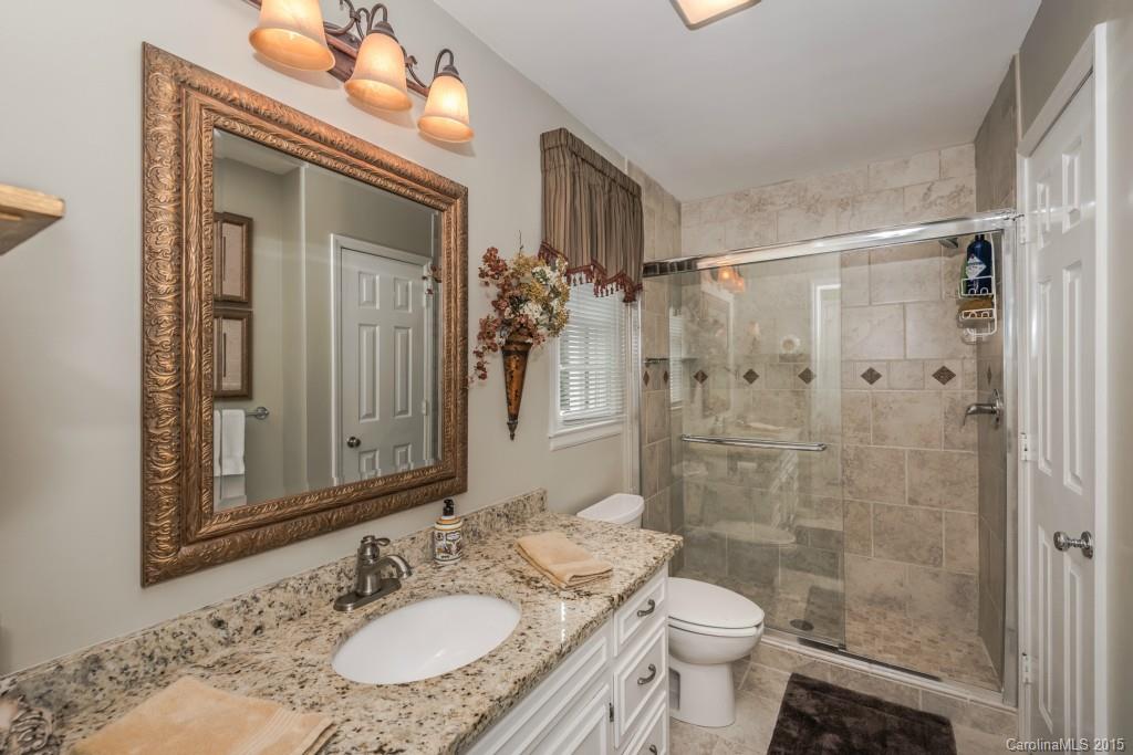 6737 Harrison Road Charlotte, NC 28270 - Photo 11 of 23 a bathroom with a granite countertop sink toilet and shower