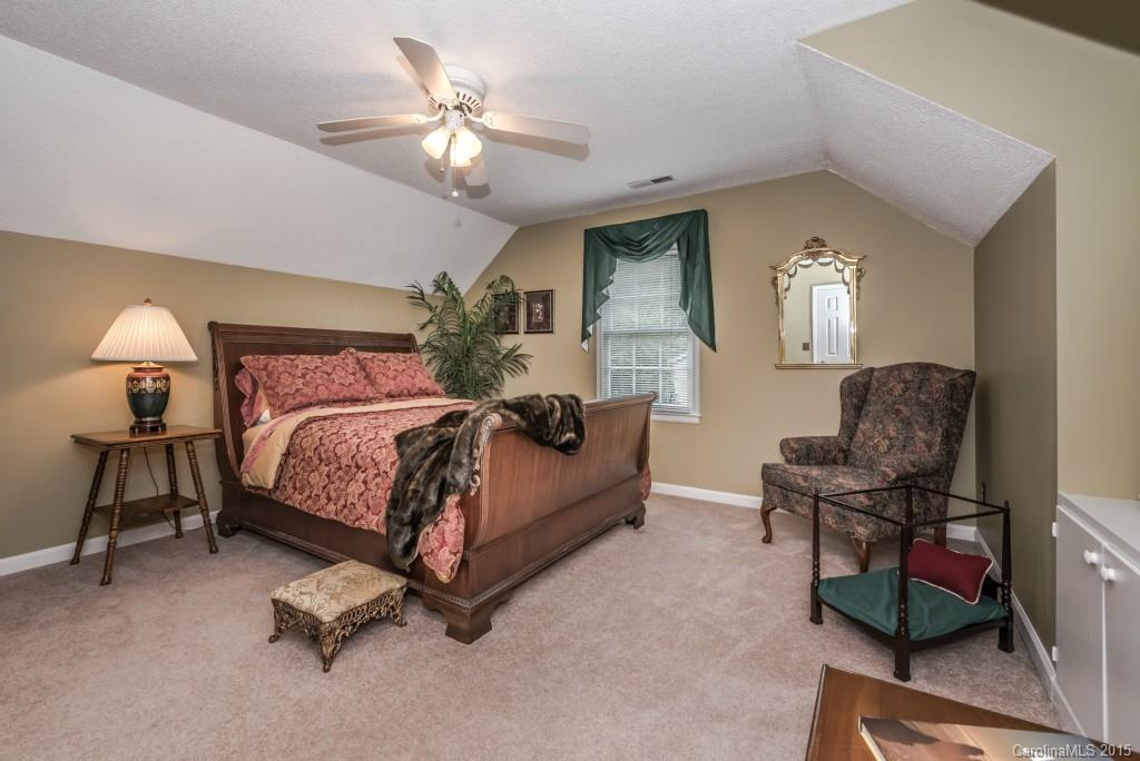 6737 Harrison Road Charlotte, NC 28270 - Photo 16 of 23 a bedroom with a bed chair and a chandelier