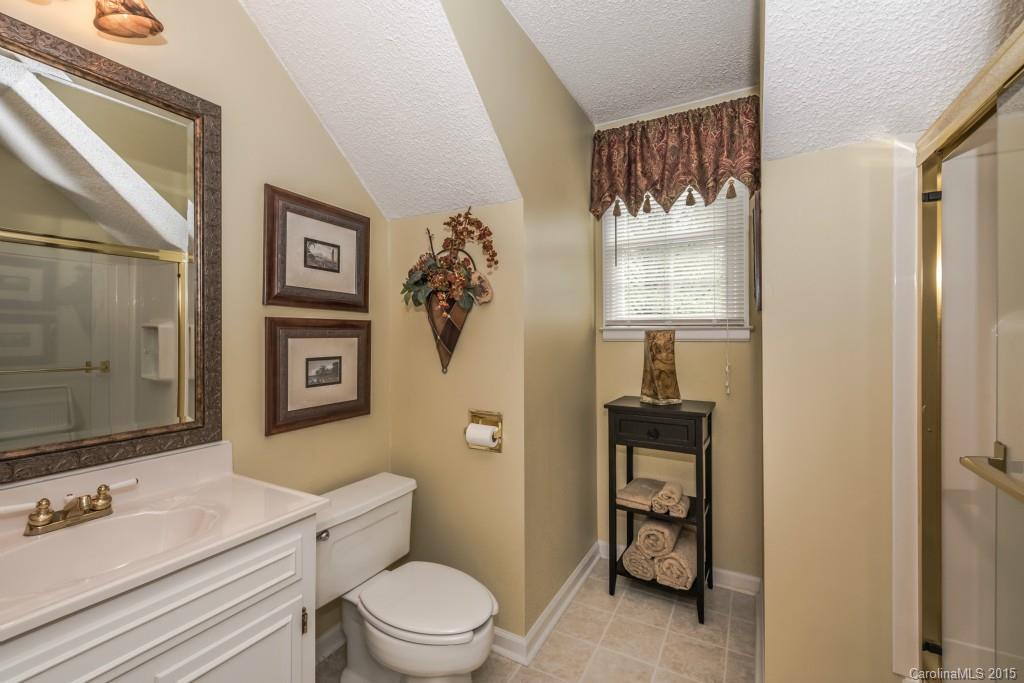 6737 Harrison Road Charlotte, NC 28270 - Photo 19 of 23 a bathroom with a toilet a sink and glass door