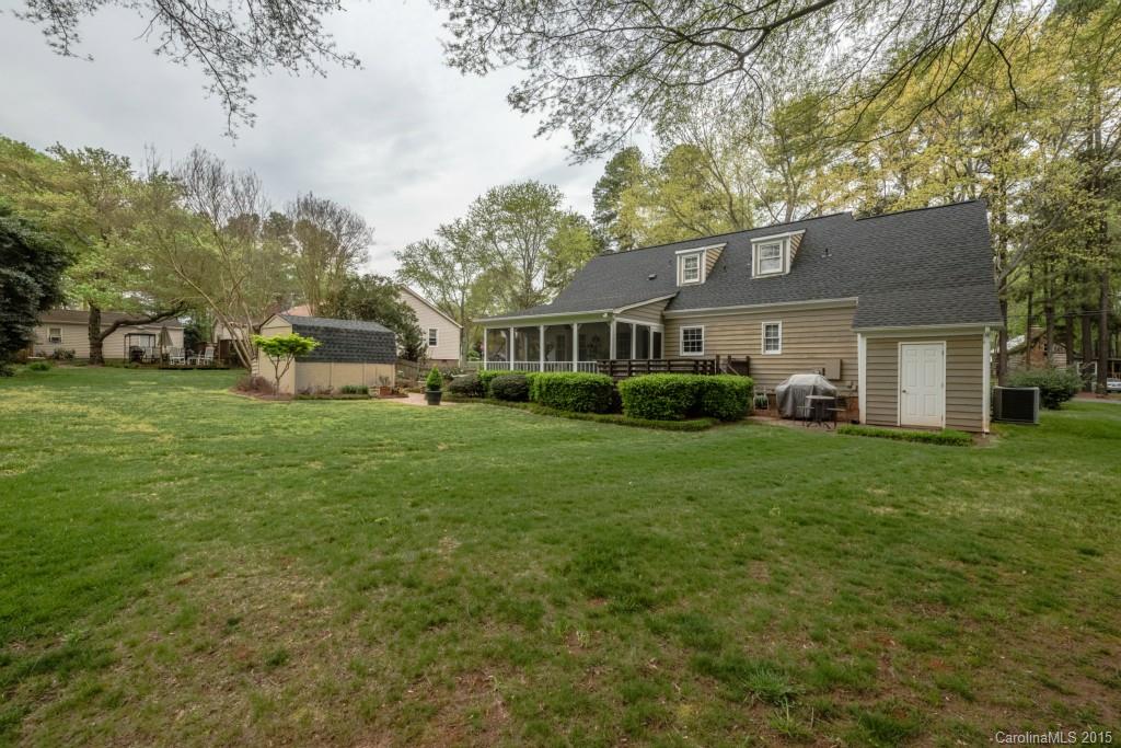 6737 Harrison Road Charlotte, NC 28270 - Photo 23 of 23 a front view of a house with a garden and trees